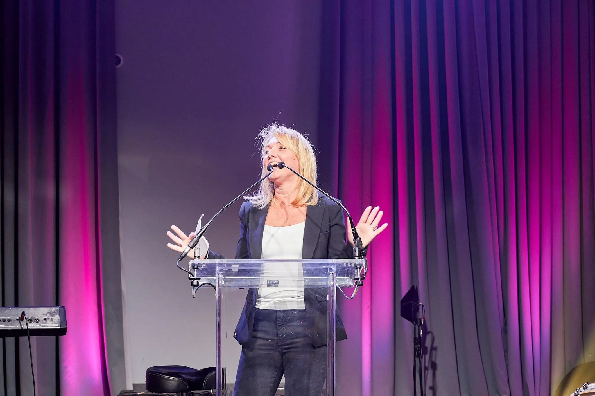 Keynote speaker on stage at a corporate event in the UK