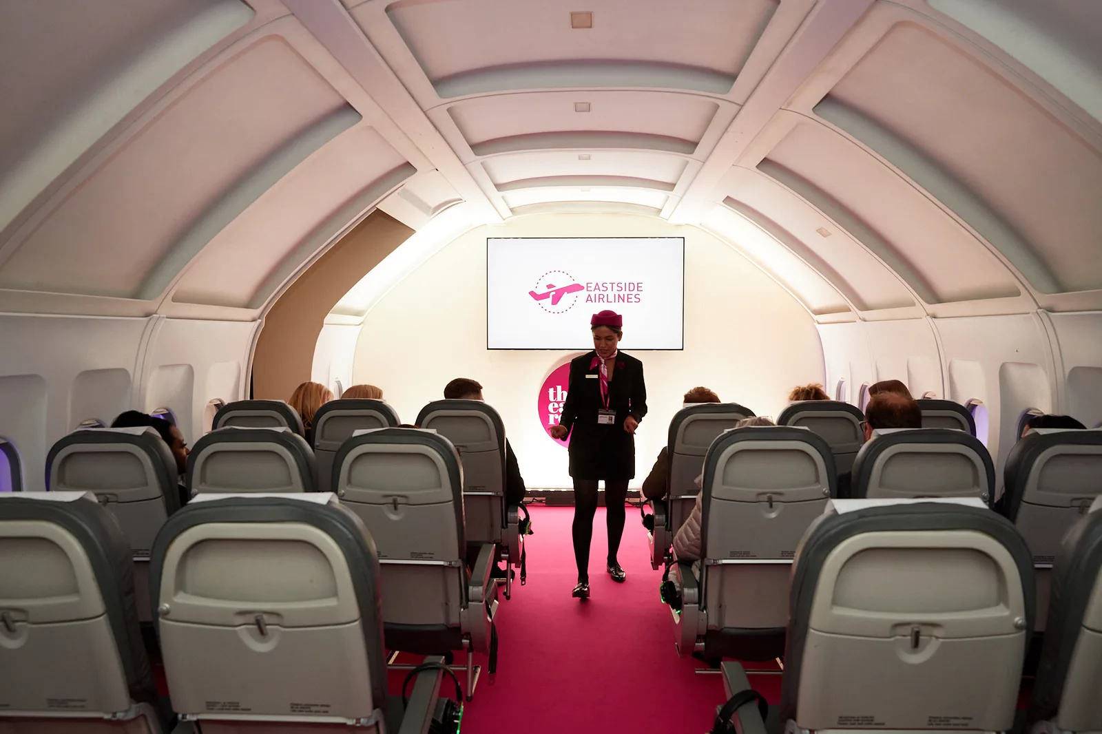 Themed aircraft cabin set with cabin crew at a Birmingham conference welcome reception