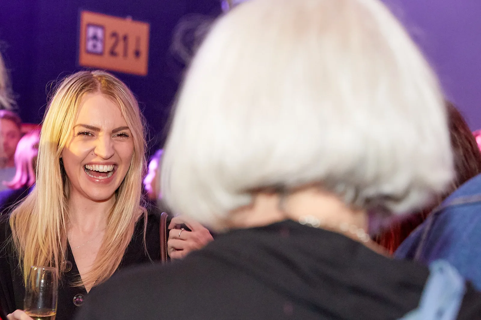 Guest laughing during a conference drinks reception