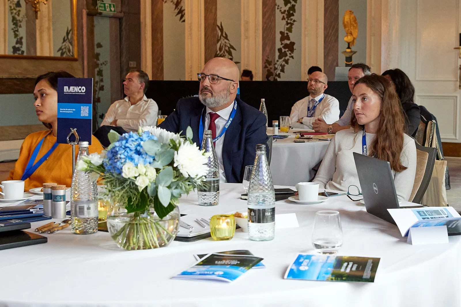 Delegates seated at tables during a conference