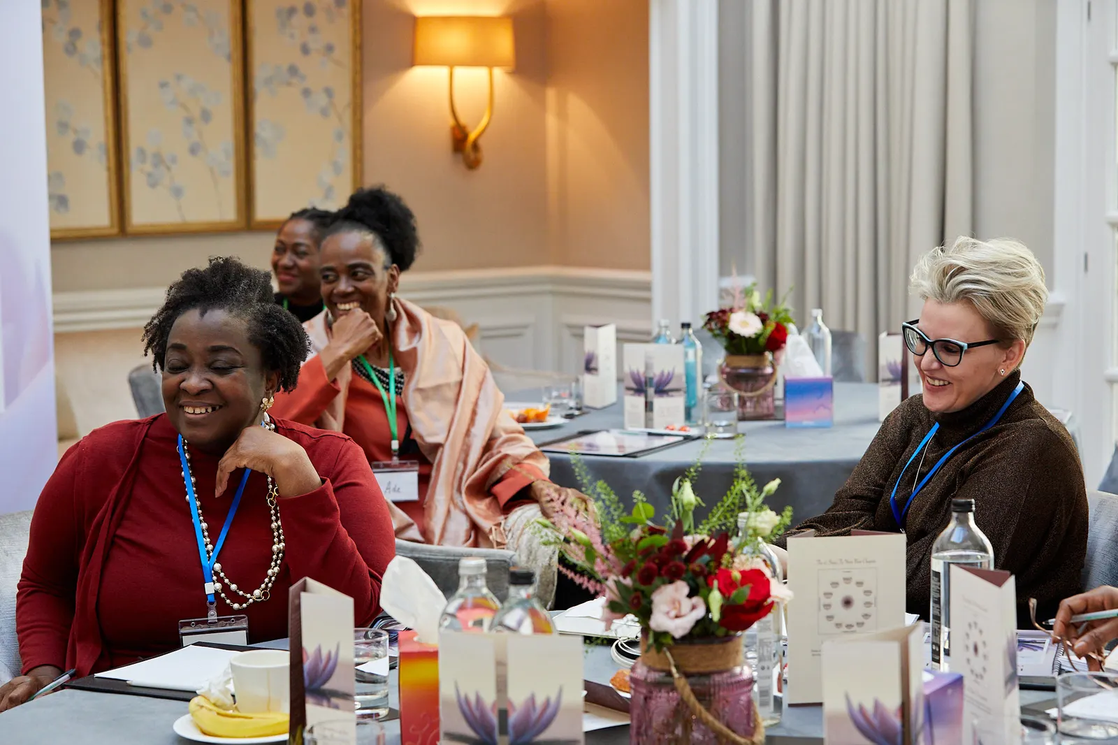 Delegates sharing a laugh around a table at a corporate away day in a hotel venue