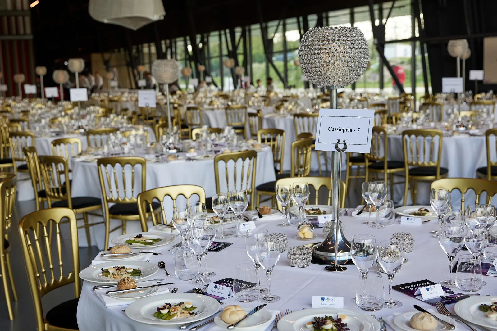 Elegant gala dinner table setting with crystal centrepiece before guests are seated