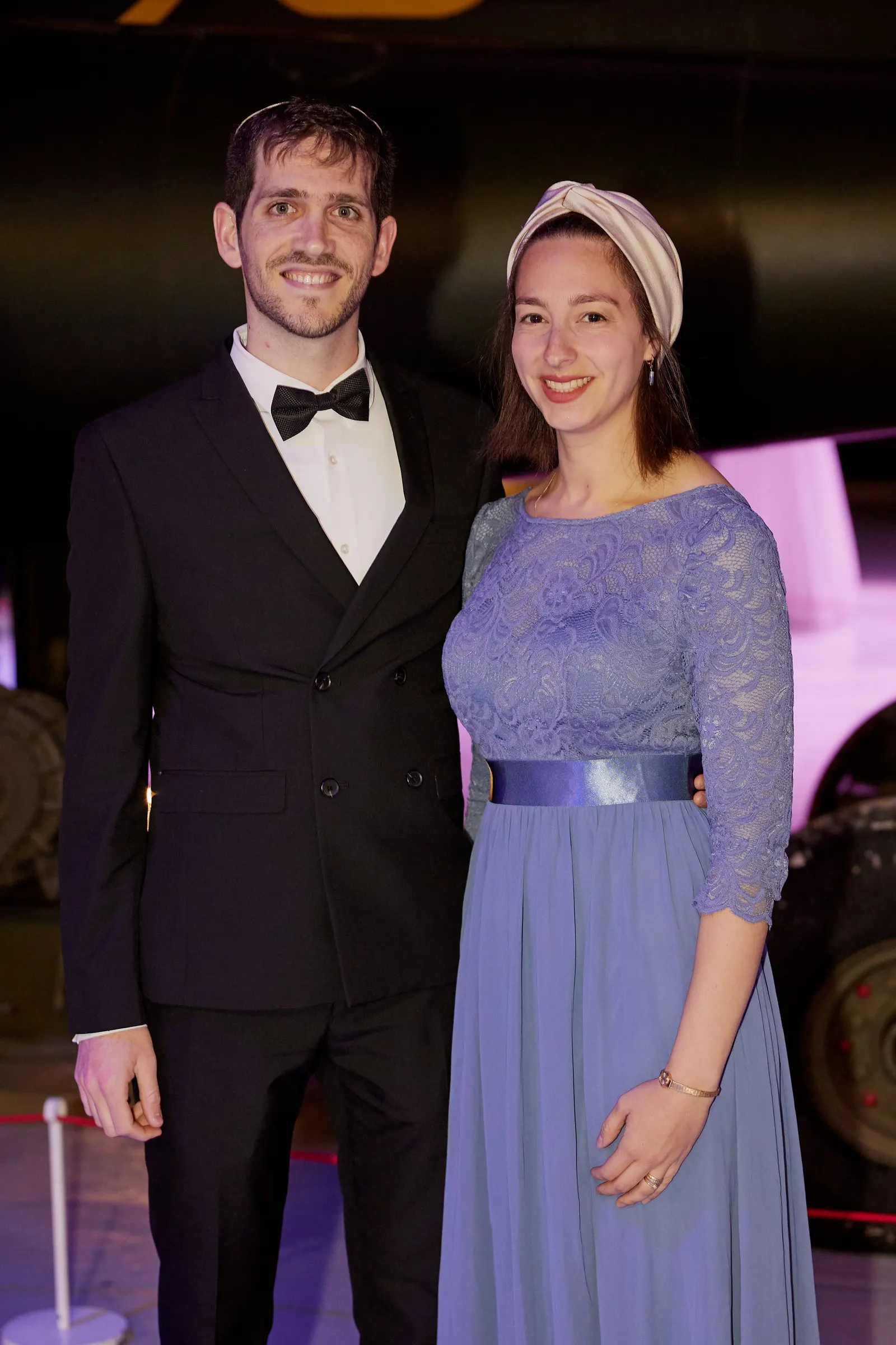 Guests photographed beside a historic aircraft at a gala reception