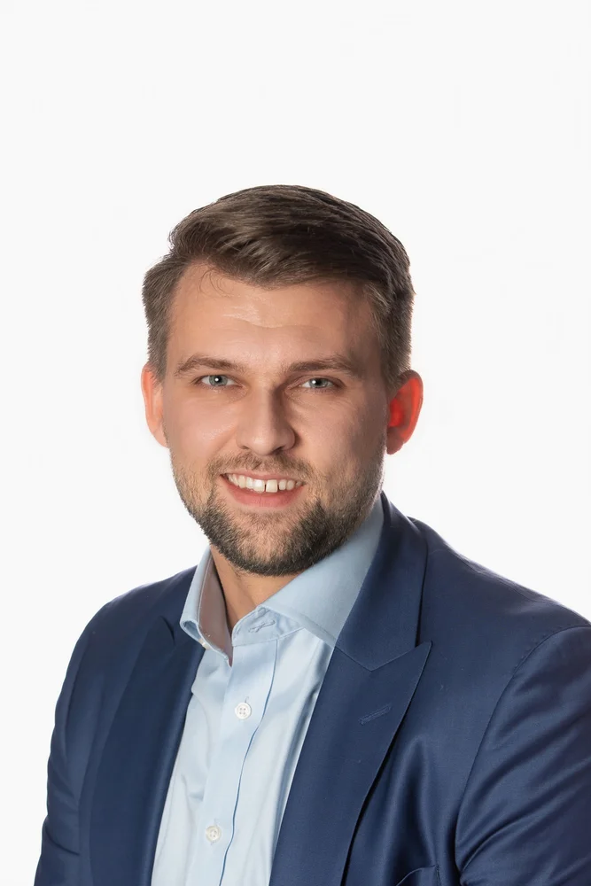 Professional corporate headshot on a white backdrop