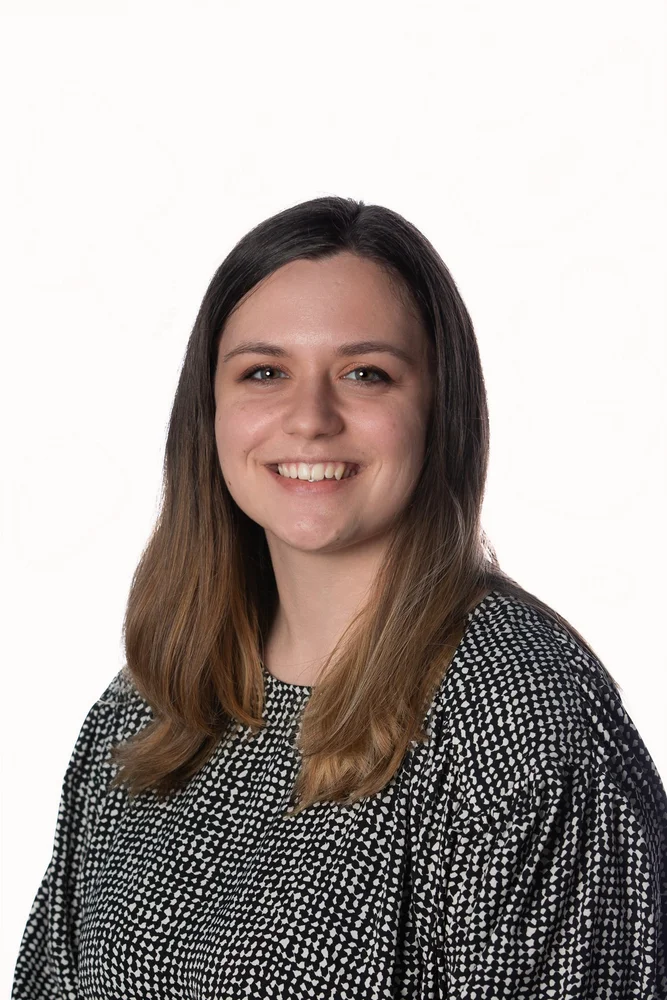 Professional corporate headshot on a white backdrop