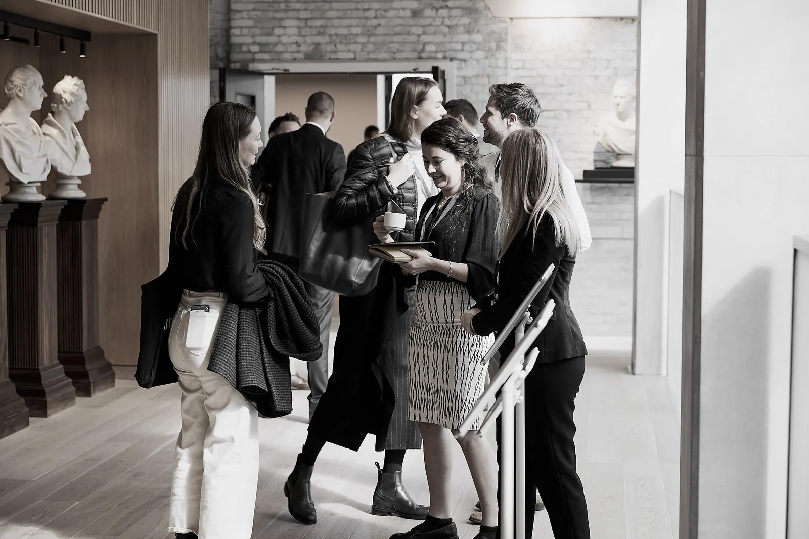Guests talking over coffee between conference sessions