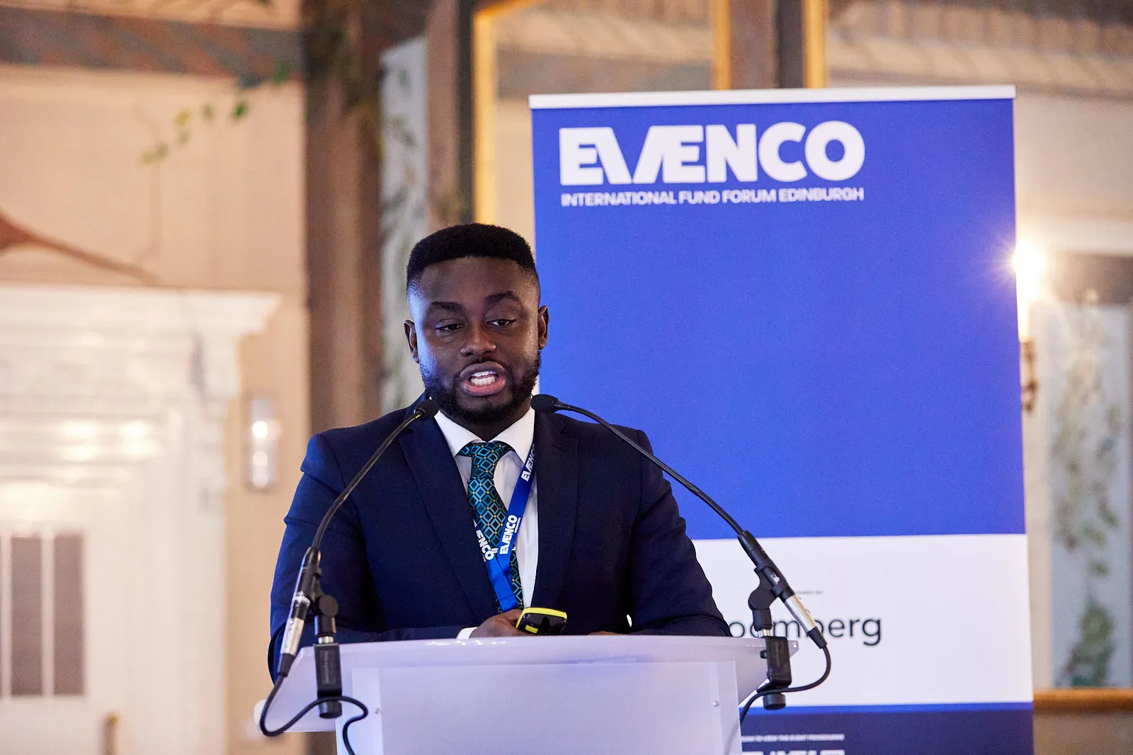 Speaker presenting at a branded lectern