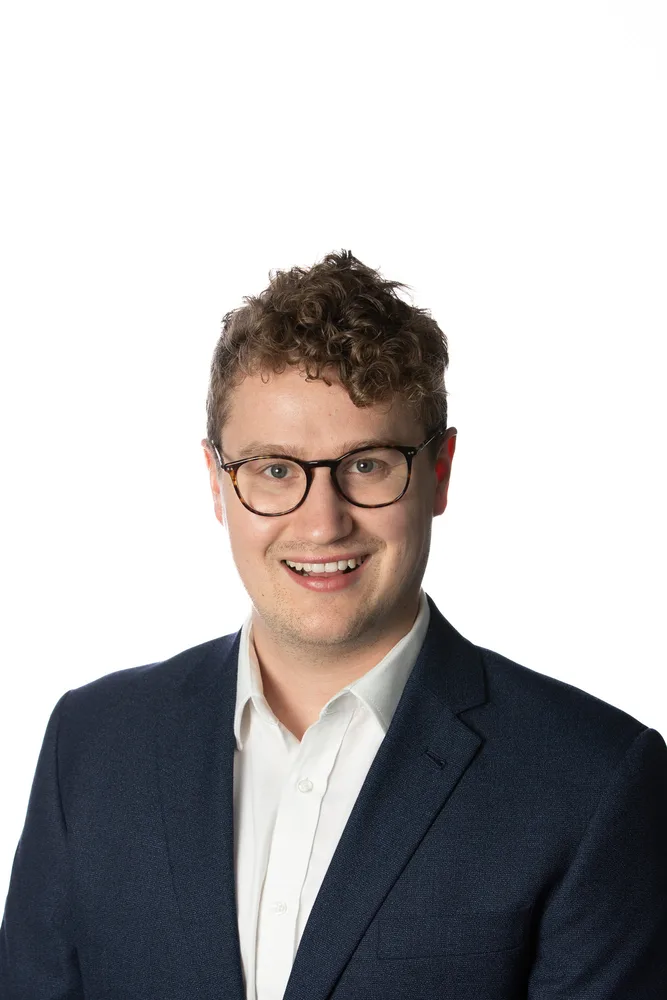 Professional corporate headshot on a white backdrop