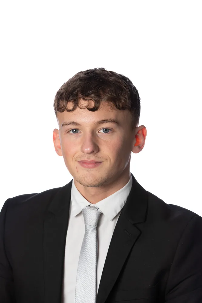 Professional corporate headshot on a white backdrop